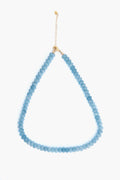 A contemporary Alexa Leigh Topaz Opal Necklace featuring round blue beads and a 14k gold-fill chain clasp in a teardrop design, perfect for modern jewelry lovers.