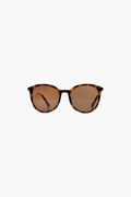 A pair of Le Specs sunglasses with brown tortoise frames, round polarized lenses, and thin arms.