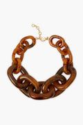 Tuckernuck Jewelry chunky necklace with brown marbled resin links and an oversized gold-plated brass clasp—perfect as a statement piece.