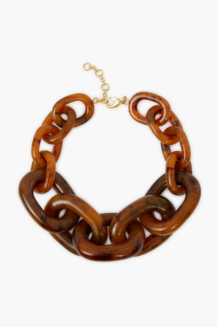 Tuckernuck Jewelry chunky necklace with brown marbled resin links and an oversized gold-plated brass clasp—perfect as a statement piece.
