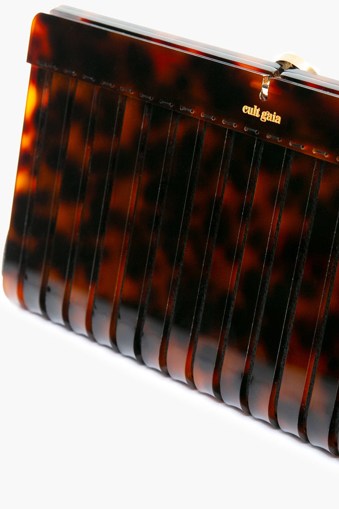Tortoise Iris Clutch: A classic, high-end box clutch in tortoiseshell-print acrylic, featuring ribbed sides, a gold clasp, and cult gaia logo, perfect for effortless, fun style.