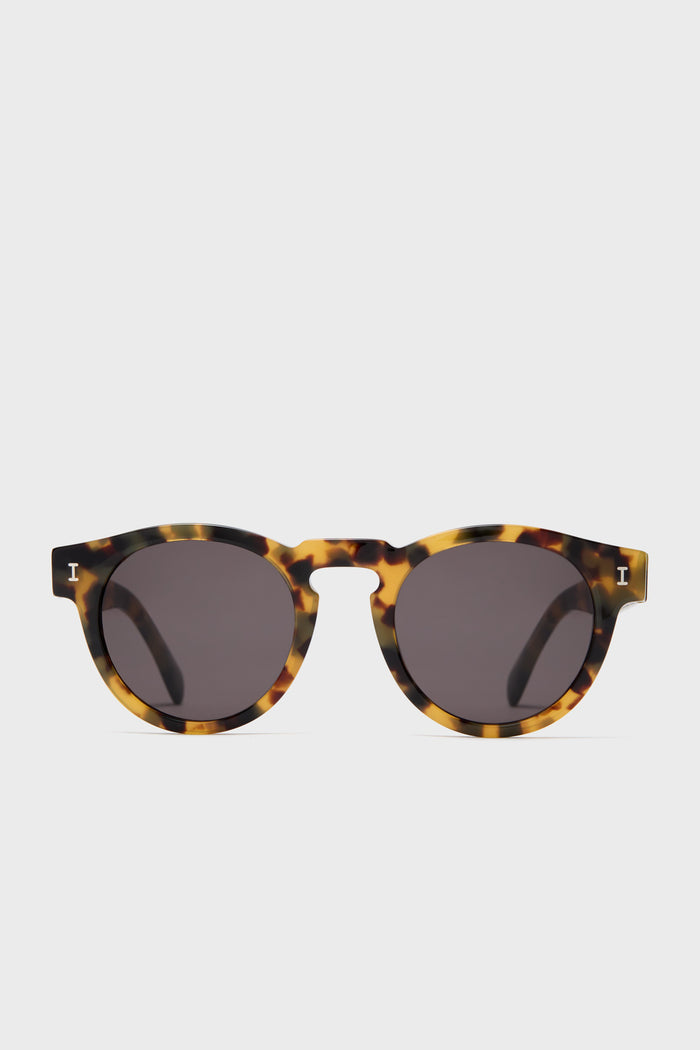 Illesteva Leonard round sunglasses featuring dark lenses and a tortoise frame, handmade in Italy.
