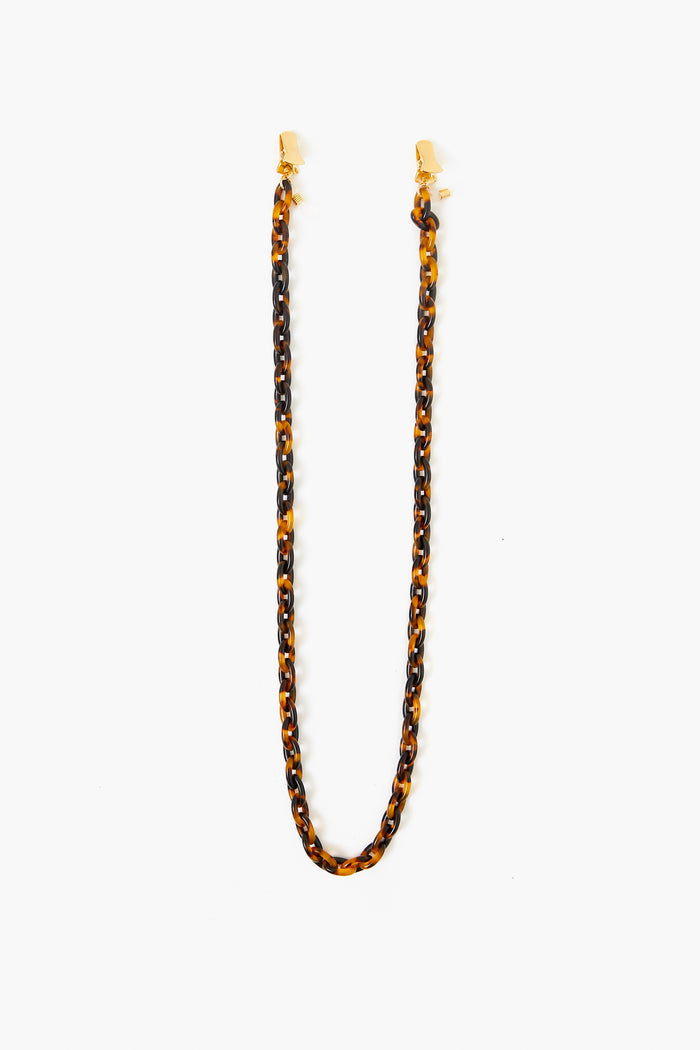 The Tuckernuck Accessories tortoiseshell-patterned chain features gold clasps at each end—perfect as a stylish sunglass holder or mask chain.