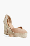The Castaner beige espadrille wedge features an ankle tie and jute-wrapped platform sole—ideal for summer style.
