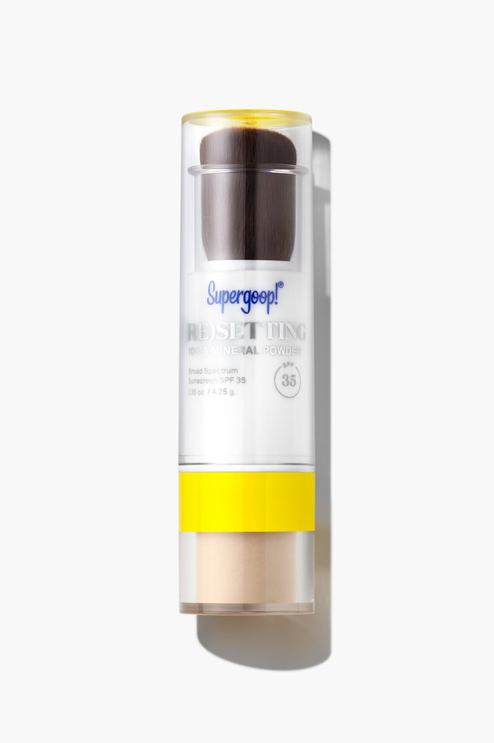 A translucent Supergoop! container with a built-in brush dispenses lightweight 100% Mineral Powder SPF 35 sunscreen for effortless, on-the-go reapplication all day.