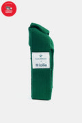 A green fabric Tuckernuck x Jollie yoga mat case with a white label stands upright; a red Children’s National benefit logo is in the top left corner.