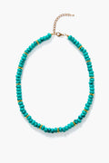 The Elfie Necklace by Petit Moments features turquoise beads, small gold spacers, and a gold clasp—capturing classic resort jewelry style.