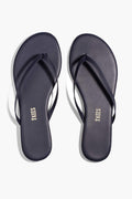 A pair of TKEES flip-flops in dark navy blue leather with thin straps, made in Brazil.