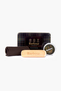 Barbour Jacket Care Kit includes a heritage tartan tin, round container, cloth, and wooden brush—ideal for maintaining your Barbour waxed cotton outerwear.