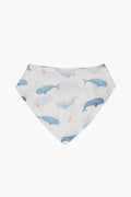 The Angel Dear white organic cotton muslin bandana bib features blue whales and small orange anchors—perfect for your little one.