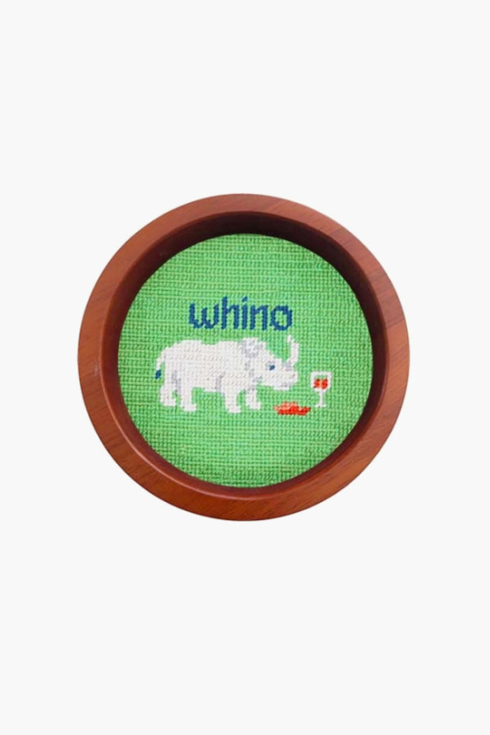This round, hand-stitched needlepoint by Smathers and Branson features a white rhinoceros beside a glass of red wine with "whino" above, making it a unique wine gift or wine bottle coaster in a wooden frame.