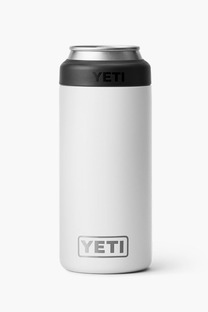 The YETI Colster is a white slim can insulator with stainless steel top and black accents. It features the YETI logo and double-wall vacuum insulation to keep your drink cold.