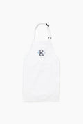 The Caton's Wharf white adjustable neck apron features a blue letter R monogram on the chest and is crafted from wrinkle-resistant fabric for durability and style.