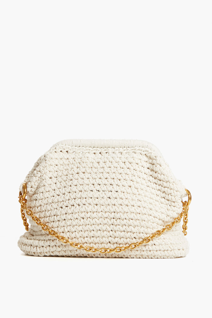 The Moda Luxe cream crocheted clutch features a short gold chain handle, ideal as a woven clutch or crochet crossbody for any occasion.