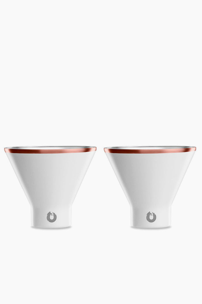 Two white, cone-shaped Snowfox shatterproof martini glasses with metallic rims are placed side by side.