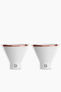 Two white, cone-shaped Snowfox shatterproof martini glasses with metallic rims are placed side by side.