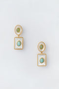 A pair of Lizzie Fortunato gold-tone drop earrings featuring circular green stones set in round and square white frames, inspired by the White Ethereal Pool Earrings.