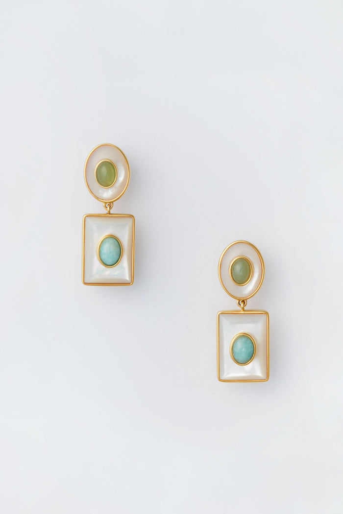 A pair of Lizzie Fortunato gold-tone drop earrings featuring circular green stones set in round and square white frames, inspired by the White Ethereal Pool Earrings.