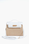 A structured Urban Expressions bag with a beige woven body, white vegan leather flap and handle, gold-tone clasp, and adjustable white shoulder strap.