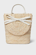The BTB woven straw handbag boasts a boho-chic style with a round flap, white handles, and a decorative white bow detail on the front.