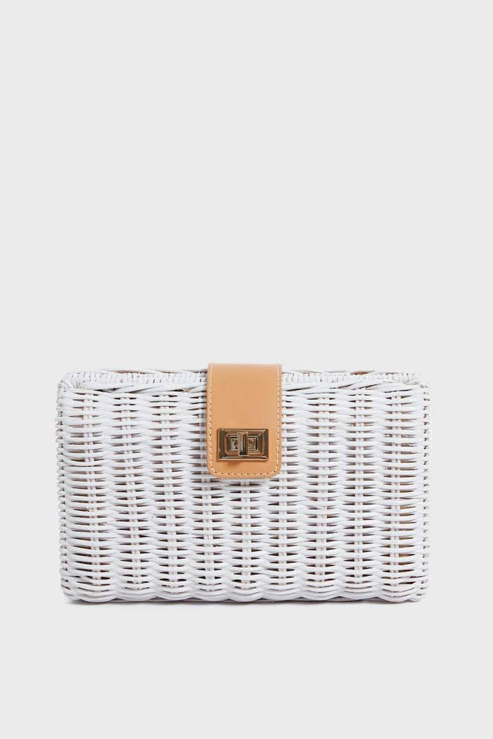 The Kayu rectangular white wicker clutch bag features a tan leather strap, gold clasp, and handcrafted basketweaving, creating a unique and sustainable accessory.