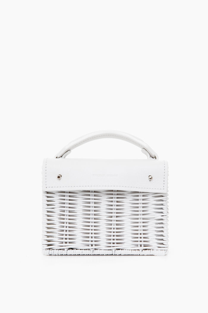 A handmade small white woven bag by Wicker Wings, crafted from sustainable materials with a short top handle and silver hardware.