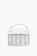 A handmade small white woven bag by Wicker Wings, crafted from sustainable materials with a short top handle and silver hardware.