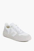 The VEJA low-top sneaker features a white design with light gray suede accents, white laces, and a white rubber sole, providing a stylish and sustainable everyday option.