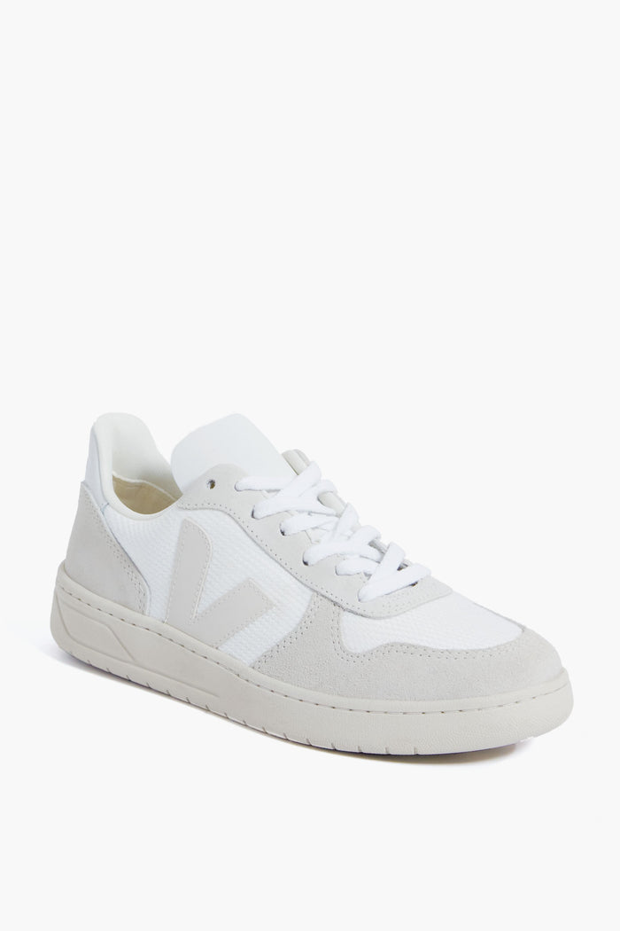 The VEJA low-top sneaker features a white design with light gray suede accents, white laces, and a white rubber sole, providing a stylish and sustainable everyday option.