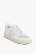 A VEJA white sneaker with an off-white sole, beige toe detail, and a light pink V logo on the side, crafted from recycled materials and displayed at a three-quarter angle.