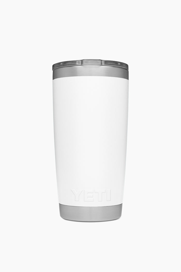 A YETI Rambler tumbler in white stainless steel stands upright, featuring a silver lid and base that showcase its vacuum insulated design.