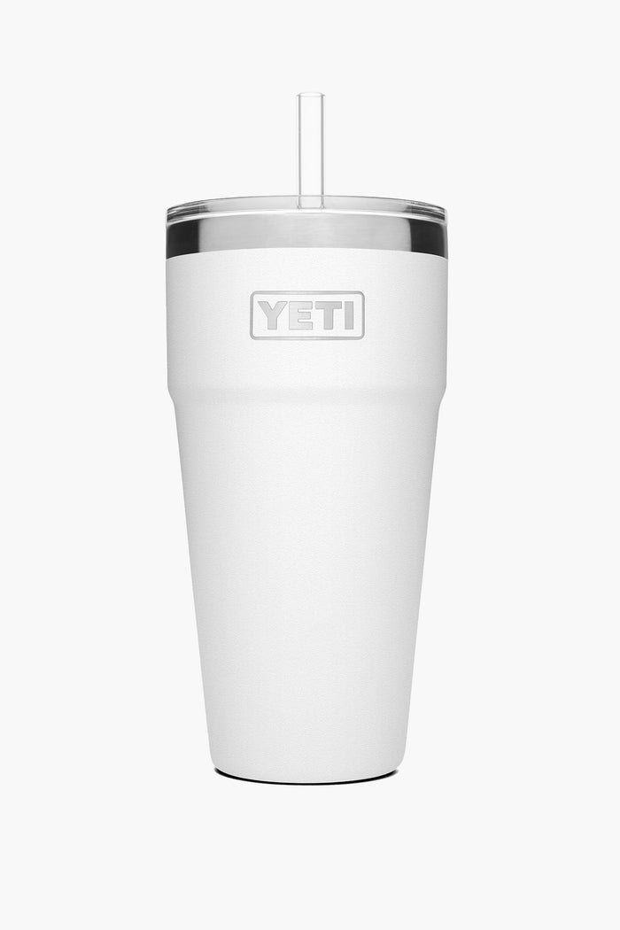 A white YETI Rambler vacuum insulated cup is shown, featuring a clear lid and straw.