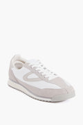 A Tretorn Rawlins 2.0 sneaker in white, featuring white laces, a textured sole, and suede and leather panel details, is pictured at a three-quarter angle.