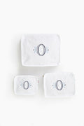 Three white seersucker travel pouches by Caton's Wharf, each in a different size with a large embroidered letter O and blue accents—ideal as a bridesmaids gift.