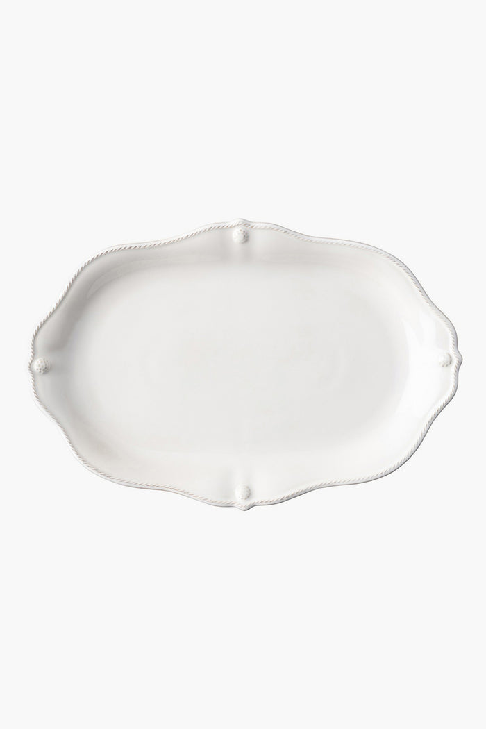 Juliska's empty, white oval ceramic stoneware platter features a scalloped edge and subtle embossed detailing—perfect for adding elegance to your dinnerware collection.