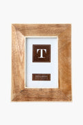 A neutral wood photo frame from Two's Company with a light brown finish, featuring a placeholder insert showing the letter T and sized for 4x6 inches (10x15 cm) photos.