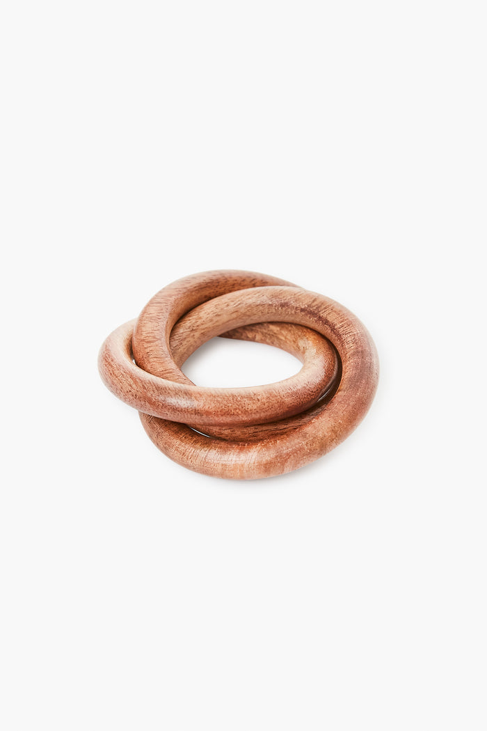 Caton’s Wharf presents a unique napkin ring: two smooth mango wood rings interlocked in a knot shape—perfect for adding elegant flair to monogrammed home goods.