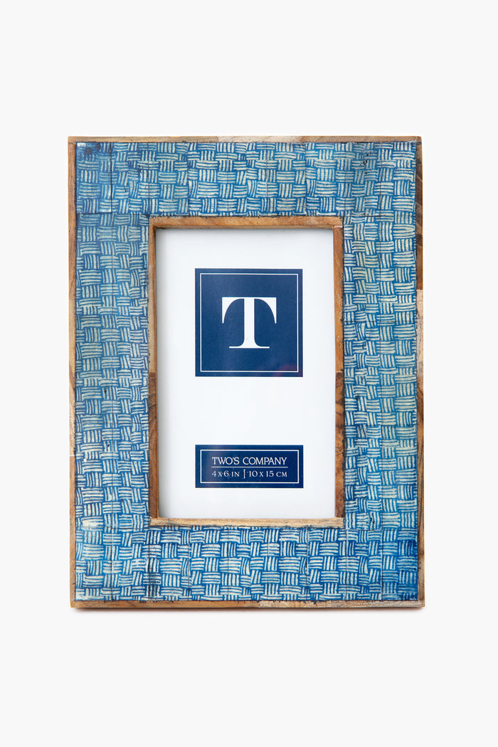 The Two's Company rectangular basket weave frame features a blue textured woven pattern, fits a 4 x 6 inch photo, and is beautifully handcrafted from mango wood.