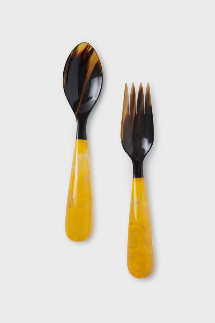 These unique Lily Juliet salad servers feature dark brown tops and yellow marbled handles, placed side by side.