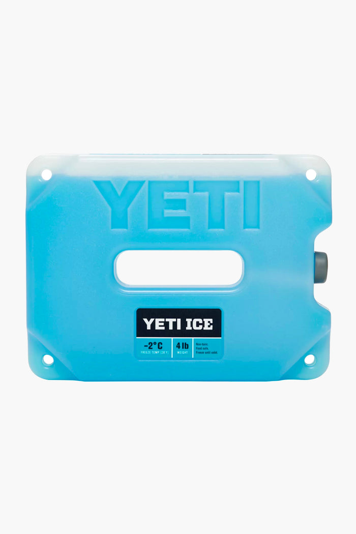 A blue rectangular YETI ICE pack with a central handle and label showing 4 lbs keeps contents at -2°C, making it an ideal YETI cooler accessory for optimal ice retention.